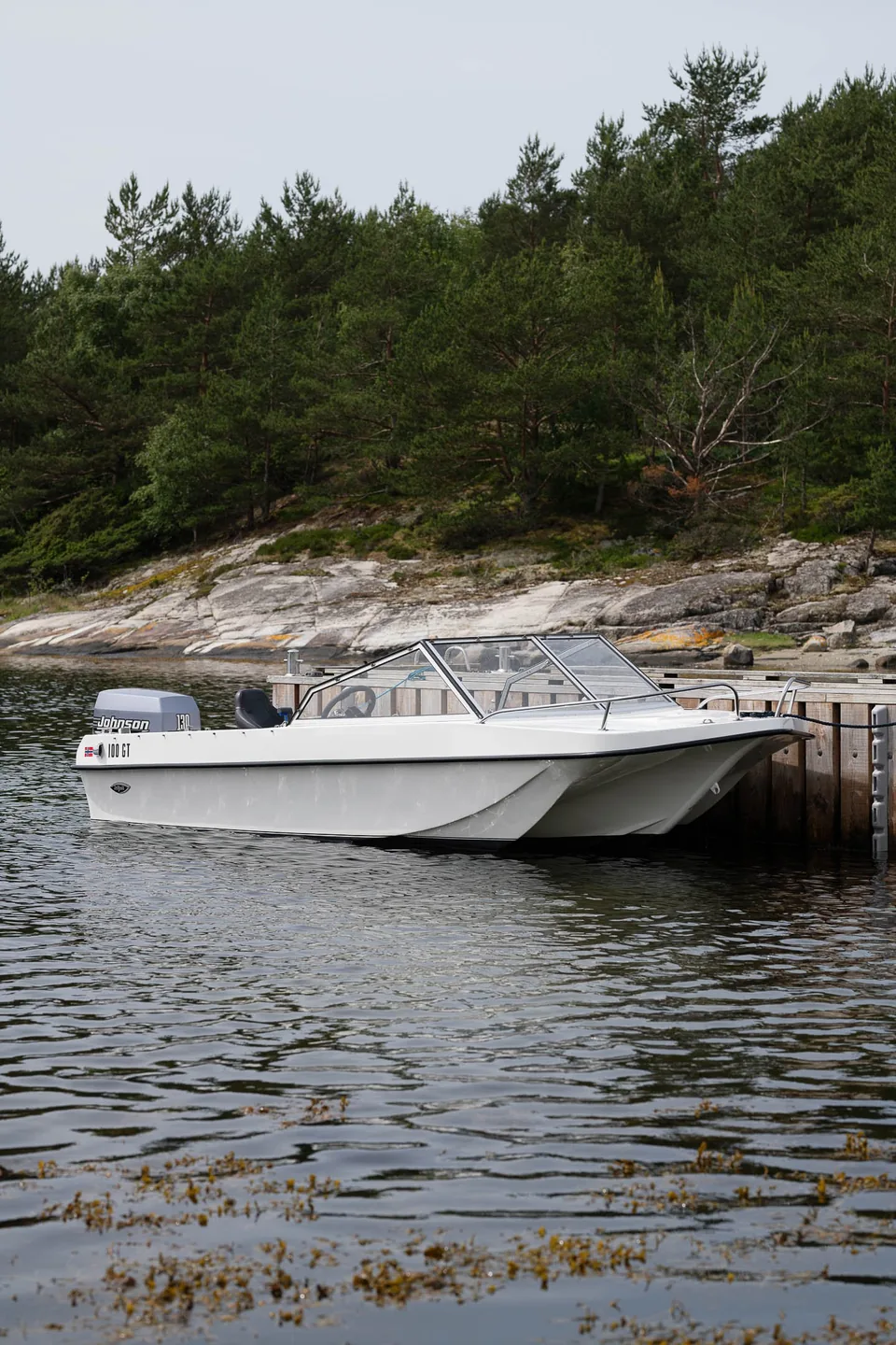 Trifoil 100GT moored beside the rocky shore