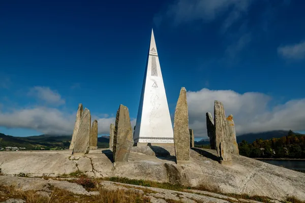 Solspeilet and its circle of standing stones beneath a blue sky