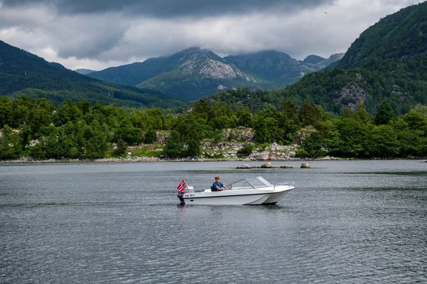 A side view of Trifoil 100GT beneath the mountains