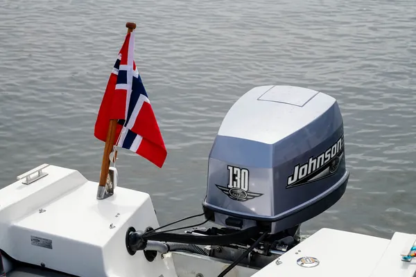 The Norwegian flag and outboard engine aboard Trifoil 100GT