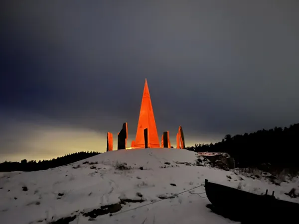 Solspeilet illuminated in orange against a winter night sky